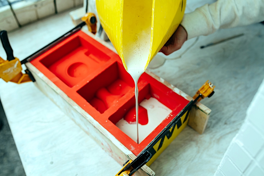 Pouring Plaster into Rubber Mold